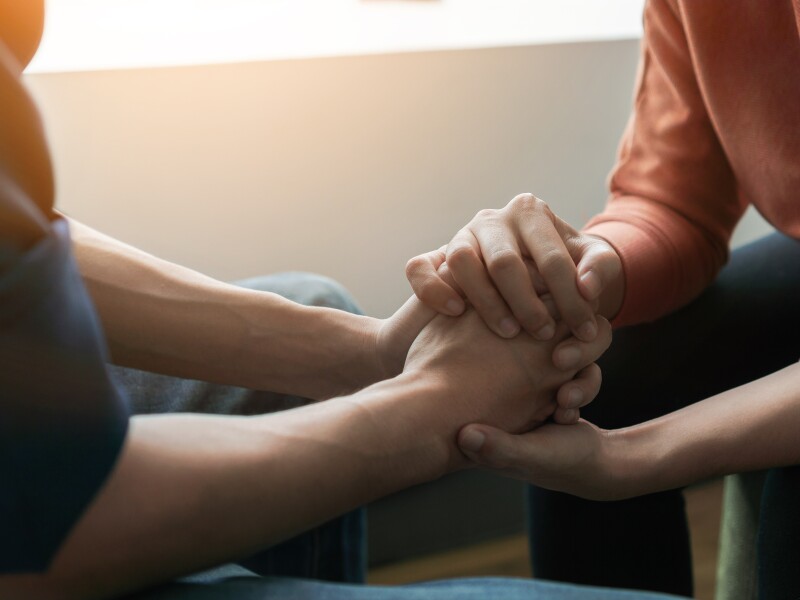 Mental health Psychologist sitting and touch hand