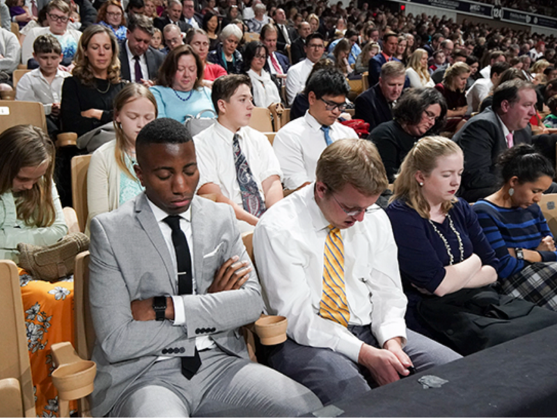 Attendees listen to the prayer during a devotional in Worcester, Massachusetts, on Sunday, October 20, 2019.