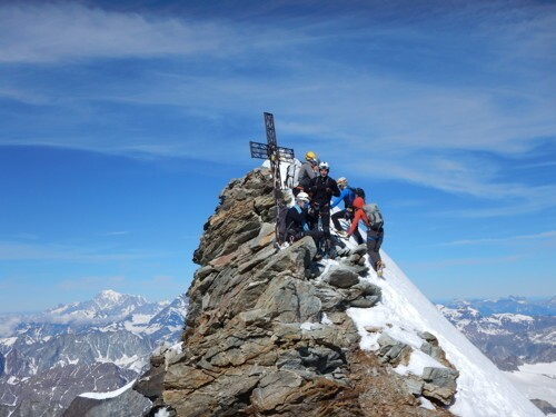 Nile Sorenson stands on top of the Matterhorn with friends.