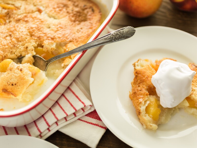 Freshly,Baked,Peach,Cobbler,With,Scoop,Of,Whipped,Cream.