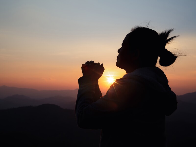Silhouette,Woman,On,Sunset,Background.,Woman,Raising,His,Hands,In