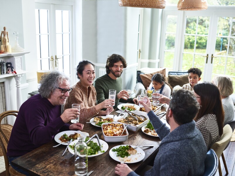Extended family toasting drinks at lunch