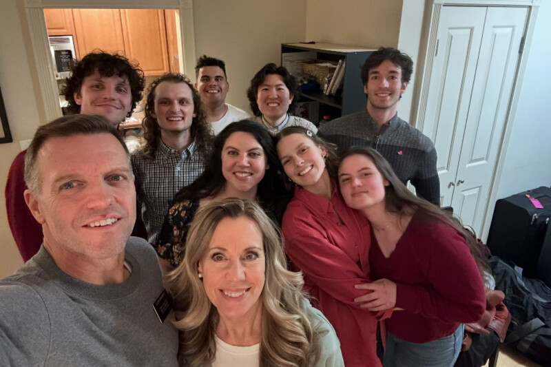 A group of young adults smiling with two senior missionaries for The Church of Jesus Christ of Latter-day Saints.