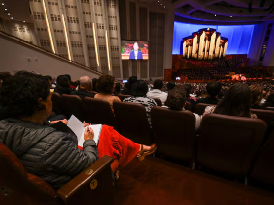 A woman takes notes as she listens to the 195th Semiannual General Conference of The Church of Jesus Christ of Latter-day Saints in the Conference Center in Salt Lake City on Saturday, Oct. 4, 2025.