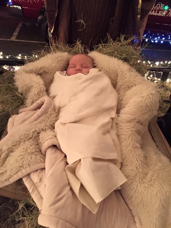 Inside the float, baby Jesus asleep in the manger.