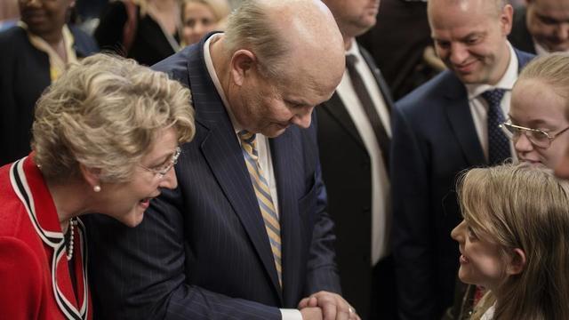 Elder and Sister Renlund greeting members of the Church