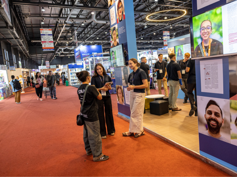 A group of people talk in front of the “Book of Mormon Experience” exhibit at the Buenos Aires International Book Fair.