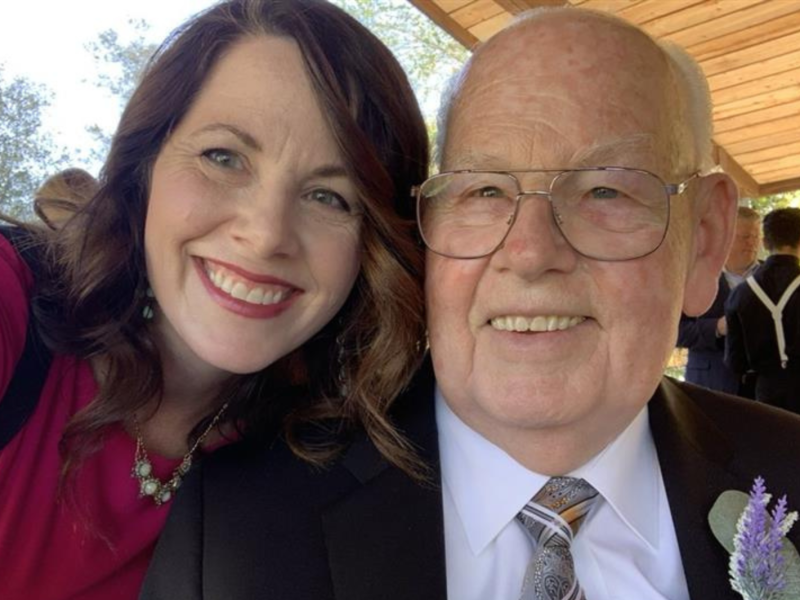 A woman smiles with her father.