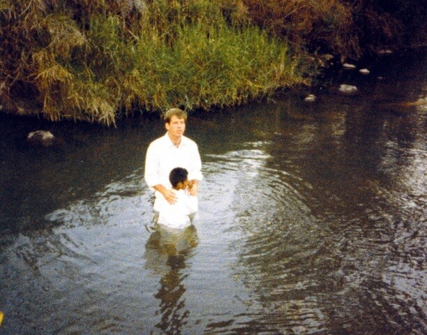 Dusty baptizing someone on his mission