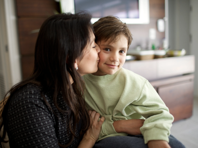 Mother kissing son on the cheek