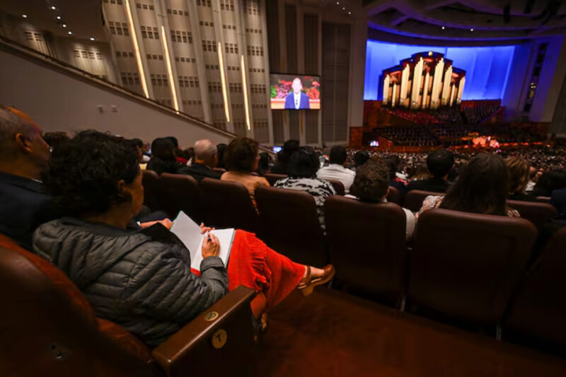 A woman takes notes as she listens to the 195th Semiannual General Conference of The Church of Jesus Christ of Latter-day Saints in the Conference Center in Salt Lake City on Saturday, Oct. 4, 2025.