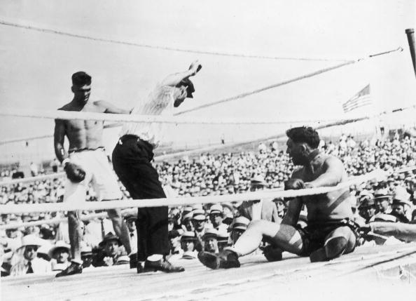 Jess Willard sits up after being knocked to the floor by Jack Dempsey during their world heavyweight title fight at Toledo, Ohio, on July 4, 1919. Dempsey won the fight at the end of the third round after Willard's second threw in the towel. (Photo by Topical Press Agency/Getty Images)