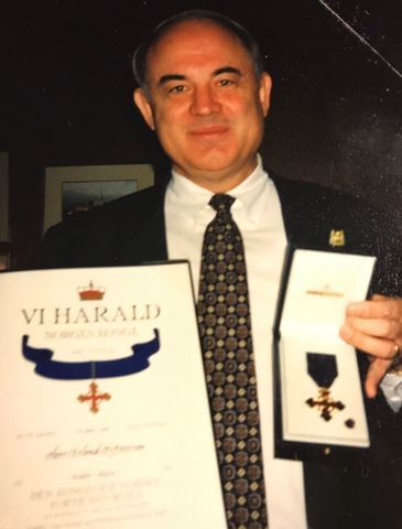 Erlend Peterson with his knighting diploma and pin