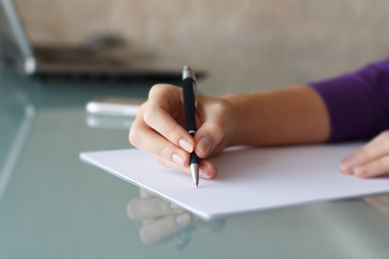 Businesswoman,Writing,With,Pen