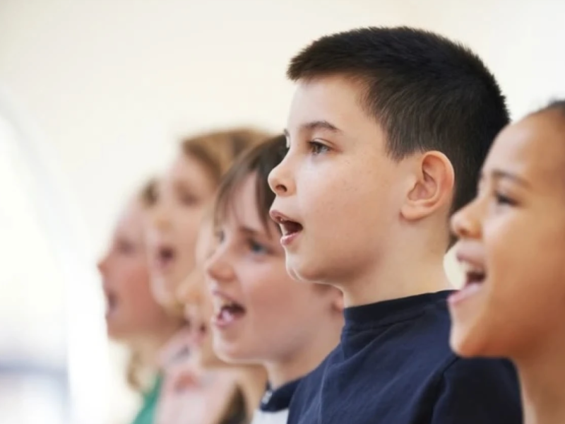 A group of six children singing.