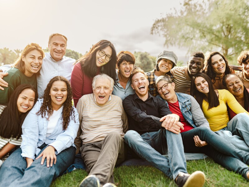 Happy,Multigenerational,People,Having,Fun,Sitting,On,Grass,In,A