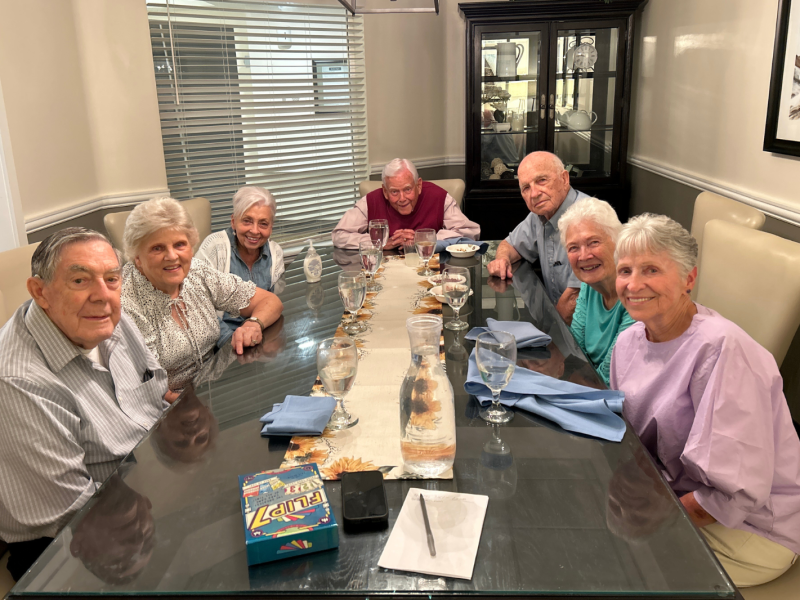 From left to right: Lowell Gould, Nancy Gould, Margie Bradford, Dallas Bradford, Candy Olson, Della Lee, and Sheri Flygare gather for games as part of their ward dinner group in Bountiful, Utah, in 2025.