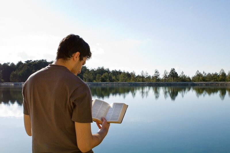 A young man reads the bible.