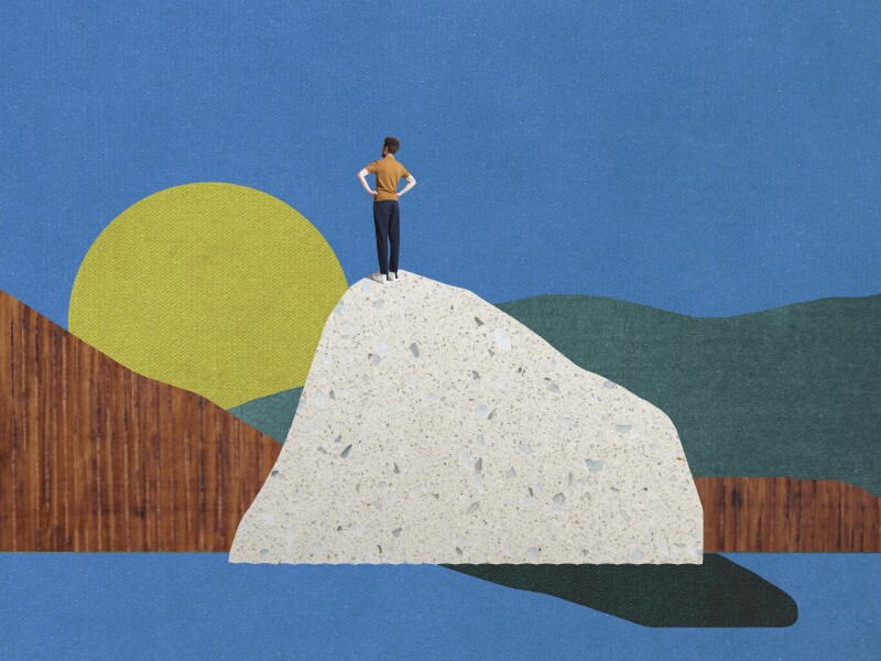 man standing on top of mountain