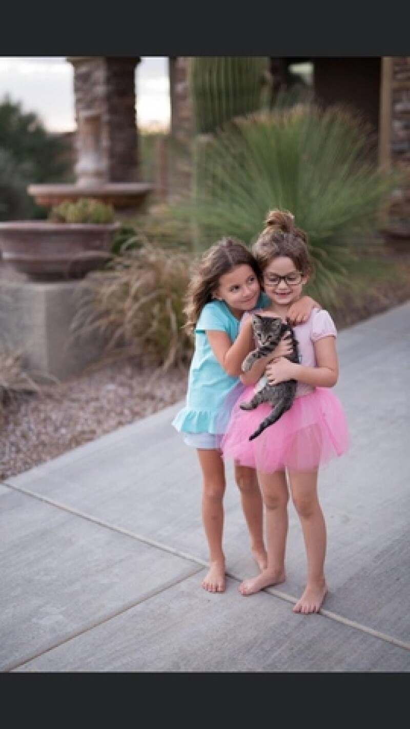 Mel's daughter with their cat, Lucy.