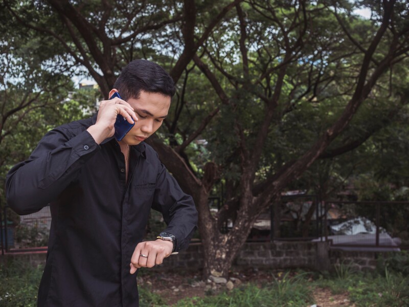 A,Handsome,Young,Man,Checking,His,Watch.,Wearing,A,Black