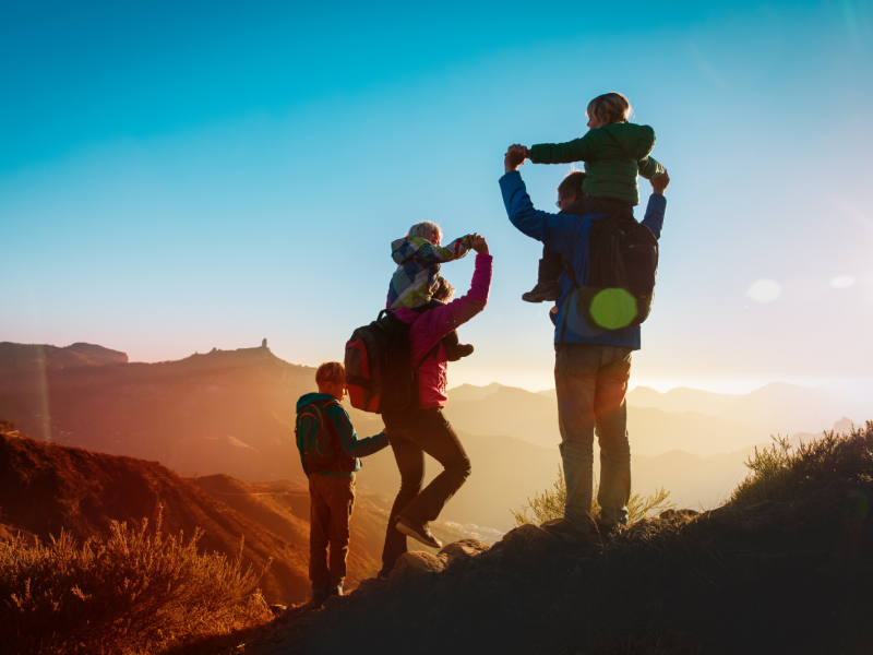 A family of four looks at the view during a hike