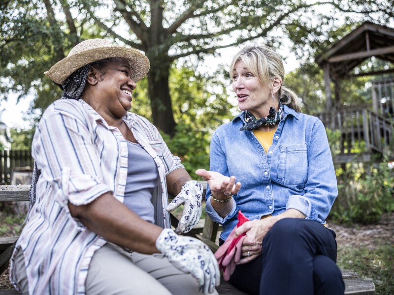 Senior women talking in community garden