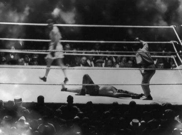 Argentine heavyweight champion Luis Angel Firpo lies knocked out by American world heavyweight champion boxer Jack Dempsey (1895-1983) at the end of their match at the Polo Grounds in New York, September 14, 1923. The bout lasted only 3 minutes and 57 seconds. (Photo by Topical Press/Hulton Archive/Getty Images)