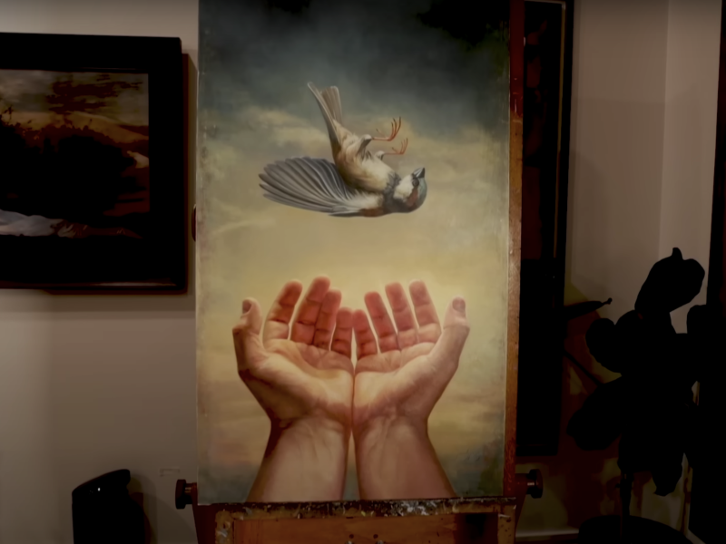 A painting of a sparrow falling into strong hands.