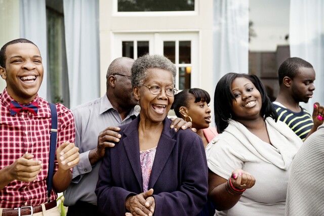 An extended family smiling and laughing together