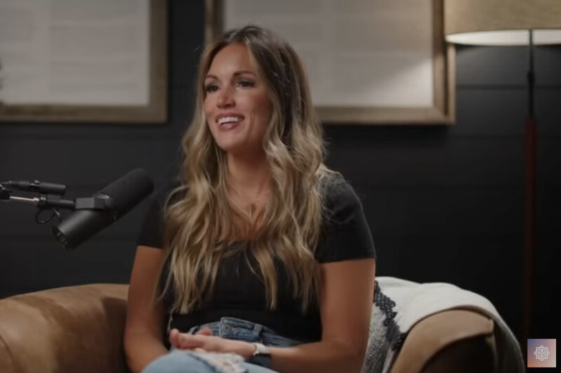 Ashly Stone sits in front of a microphone