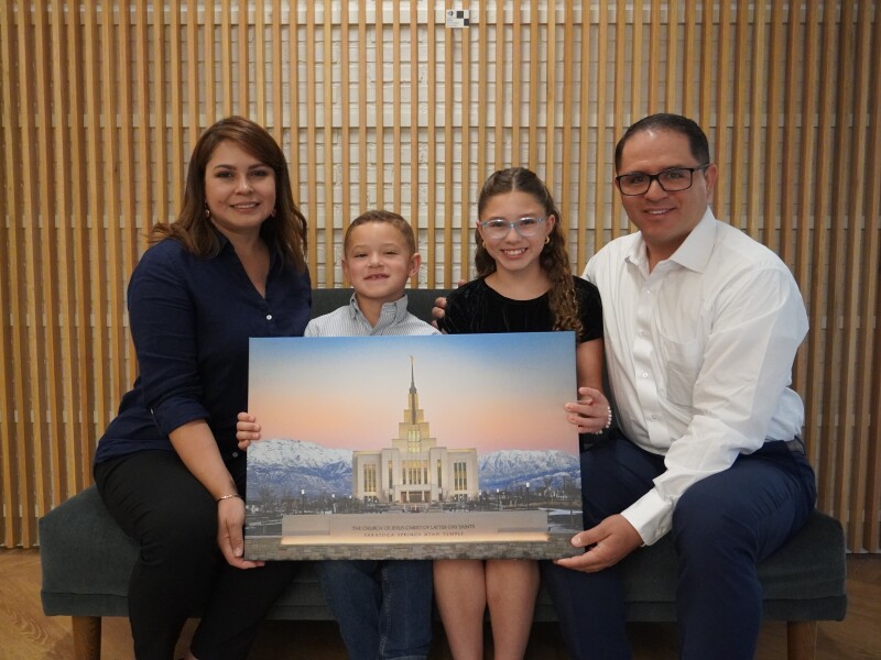 The Maradiaga family holds a canvas of the photo Eduardo took of the Saratoga Springs Utah Temple. From left to right: Giselle, Eduardo Enrique, Bryana Giselle, and Eduardo.