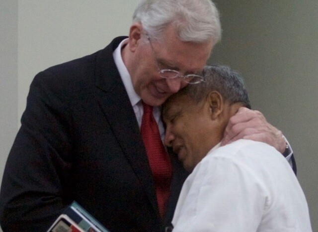 Elder Christofferson hugging a church member