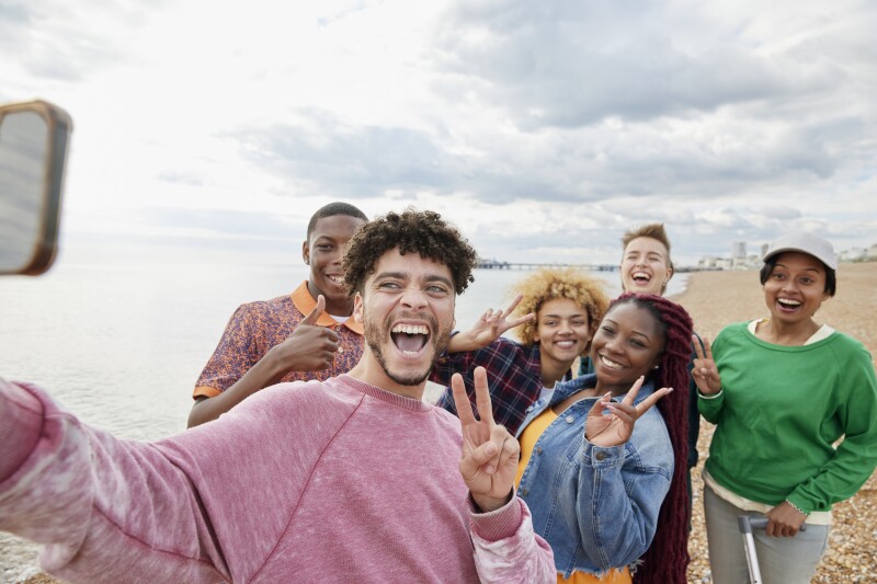 Group of friends taking selfie on sunny beach