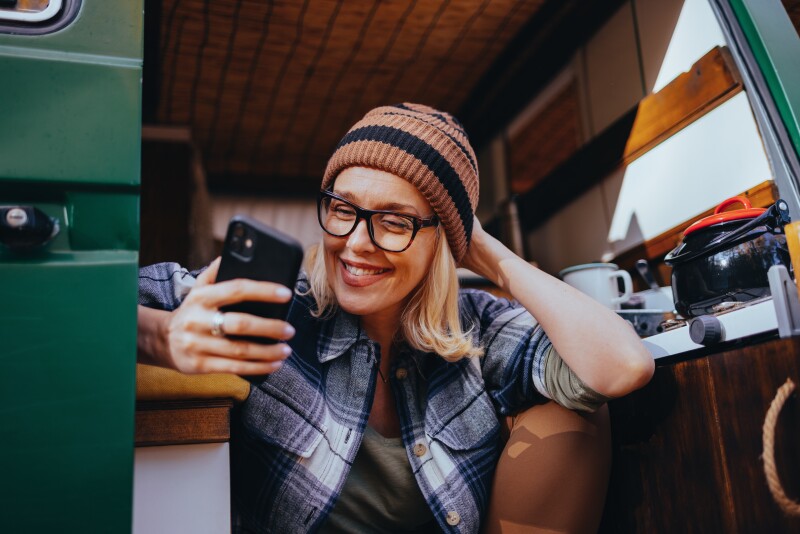 Portrait of a Beautiful Woman Using Her Phone While Camping