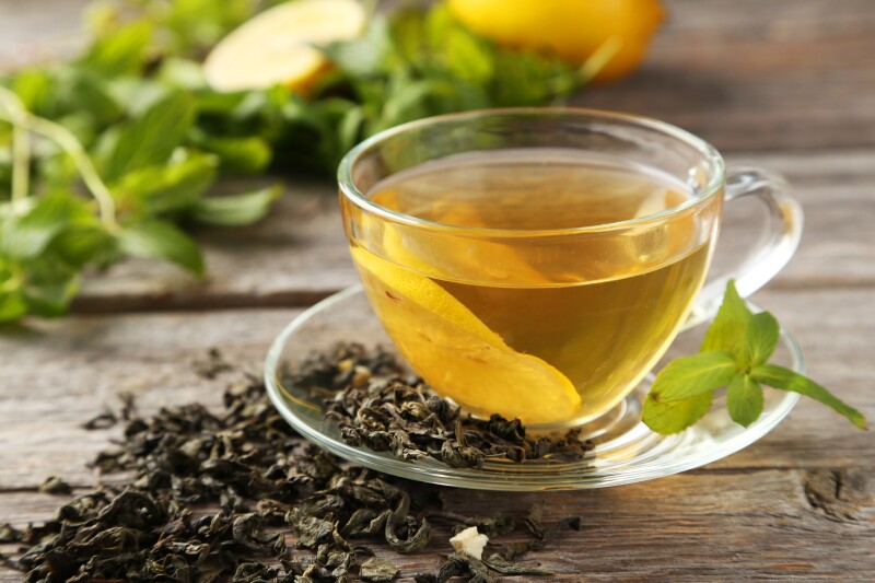 Cup,With,Green,Tea,On,Grey,Wooden,Background