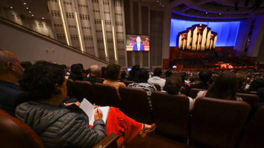 A woman takes notes as she listens to the 195th Semiannual General Conference of The Church of Jesus Christ of Latter-day Saints in the Conference Center in Salt Lake City on Saturday, Oct. 4, 2025.