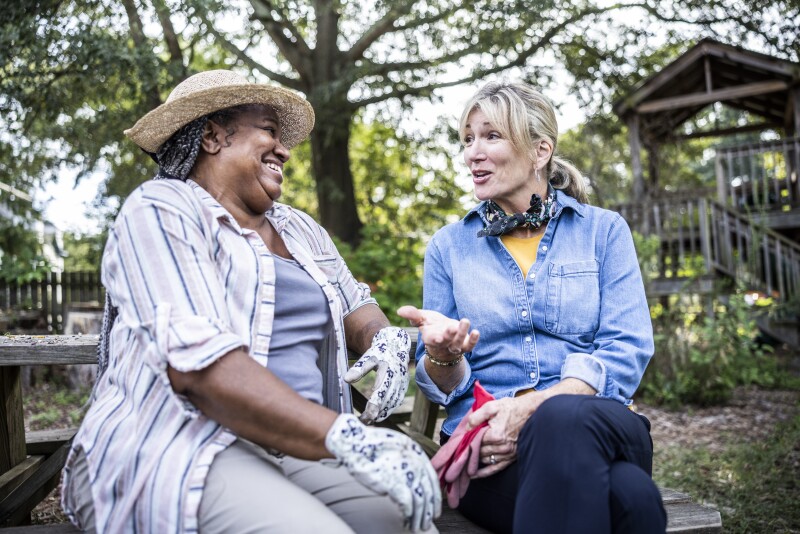 Senior women talking in community garden