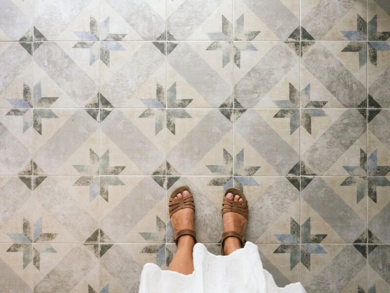 Woman standing on ornate tiled floor