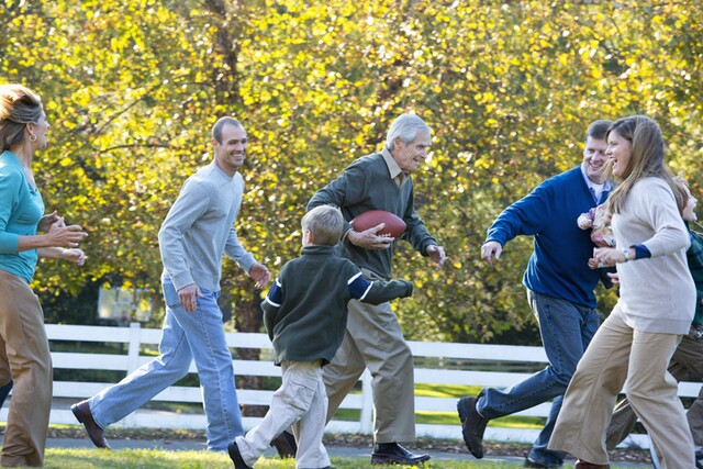 An extended family playing football together