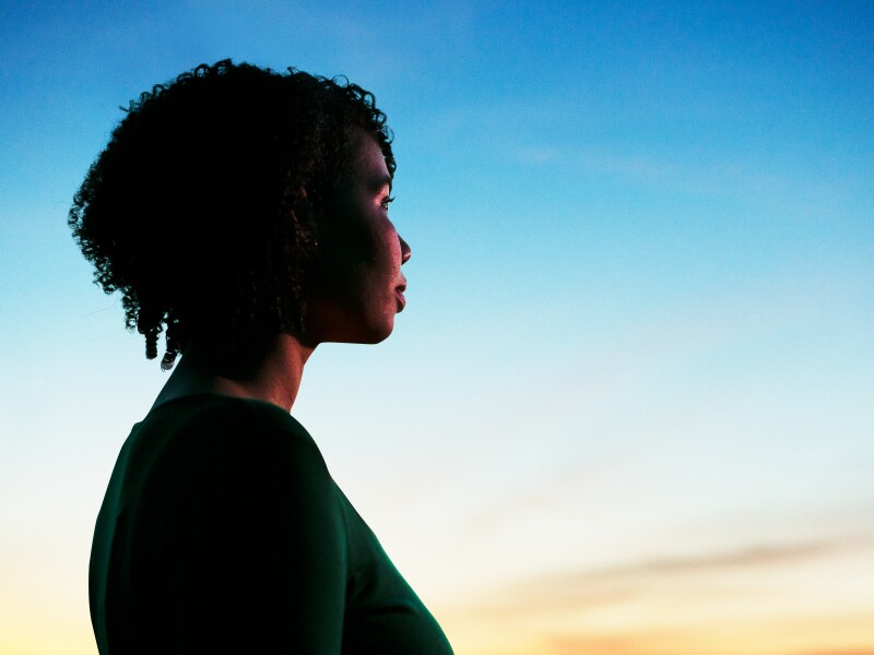 Woman looking ahead at dusk