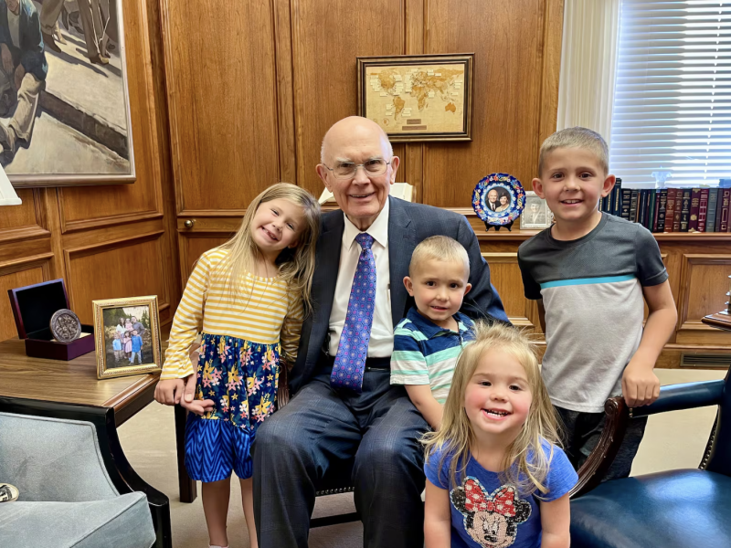 President Dallin H. Oaks smiles with four great-grandchildren in his office at the Church Administration Building.