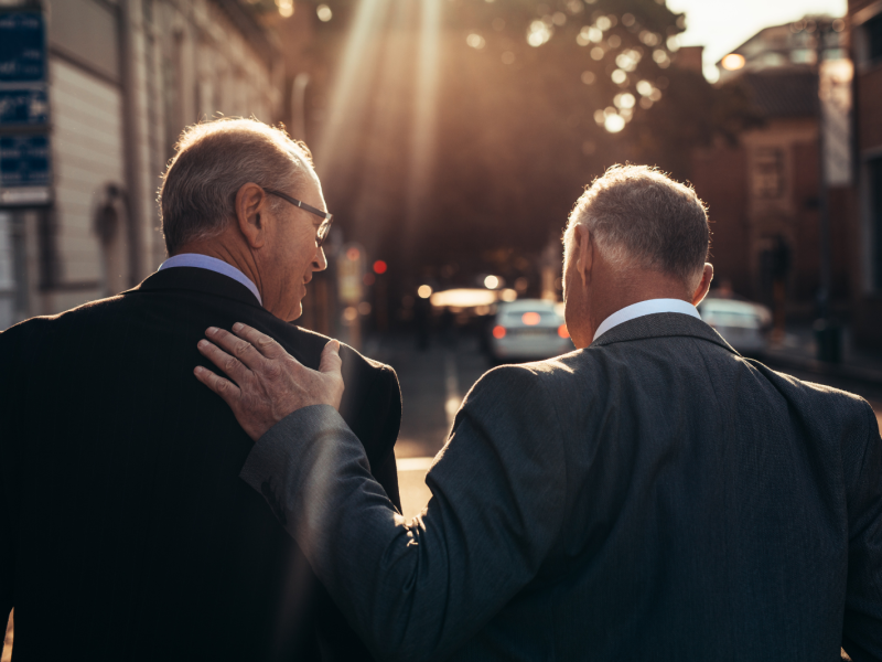 Senior businessmen walking together outdoors