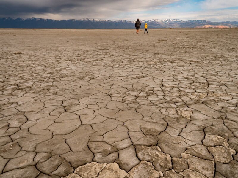 father and son walking in a dry lake bed in antelope island Utah