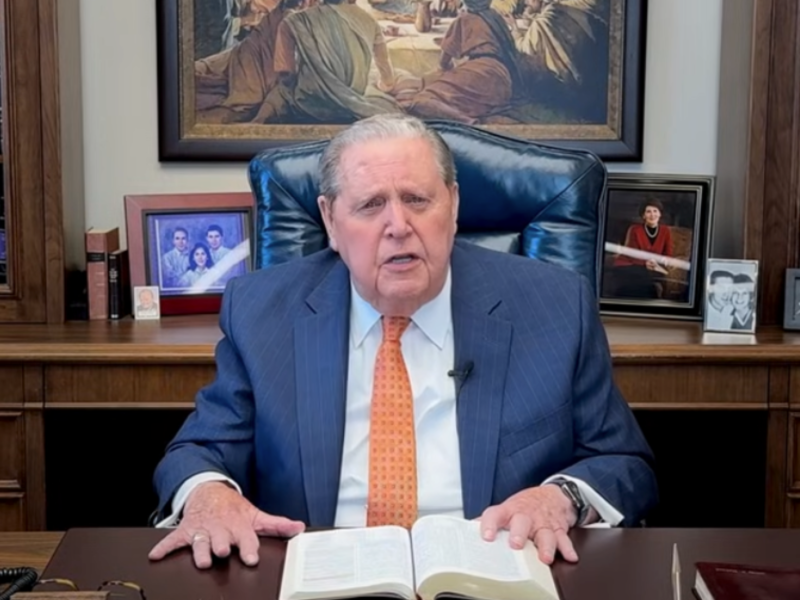 President Jeffrey R. Holland sits at his office desk with an open copy of the Bible.