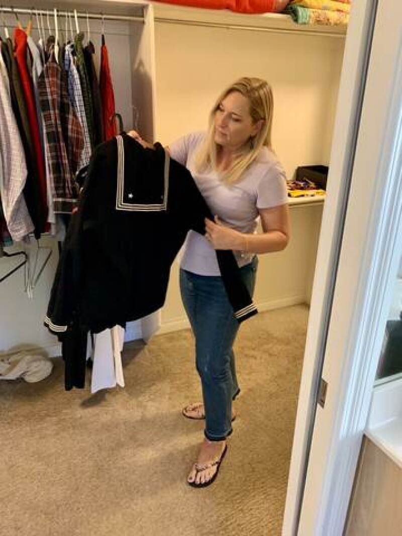 Luanne holding her father's Navy uniform.