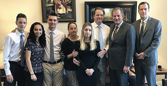 Elder Stevenson with the Petty family, who lost their daughter and sister in the Parkland shooting.