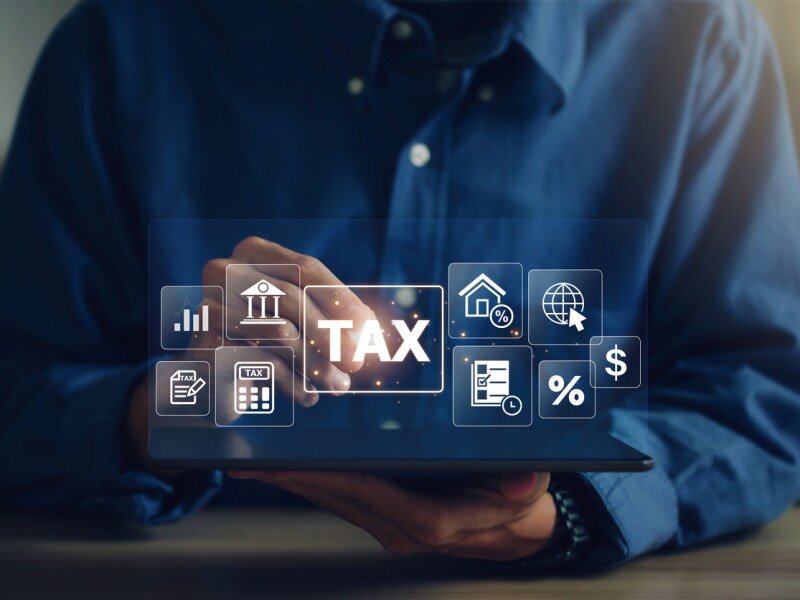 E-tax, A Businessman using a tablet to fill in the income tax online return form for payment.Calculation of tax return.Government, state taxes. Data analysis, paperwork, financial research, reports.
