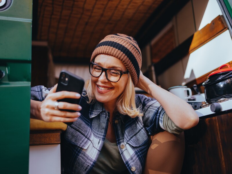 Portrait of a Beautiful Woman Using Her Phone While Camping