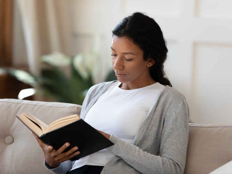 Focused,African,American,Female,Sit,Relax,On,Sofa,In,Living